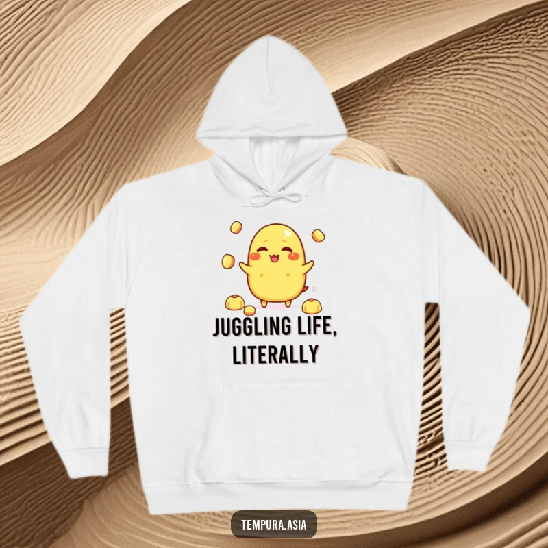 Funny tamagoyaki character giggling while juggling small rice balls on a warm hoodie, ideal for humorous and cozy wear.